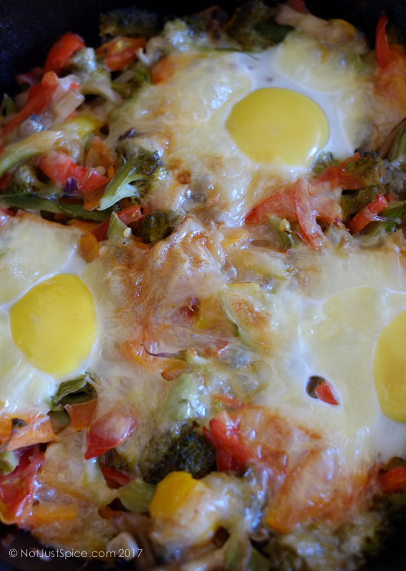 Baked Eggs on a Bed of Vegetables on notjustspice.com