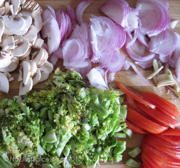 Chopped mushroom, broccoli, onions, tomatoes and garlic for baked eggs with broccoli and mushroom